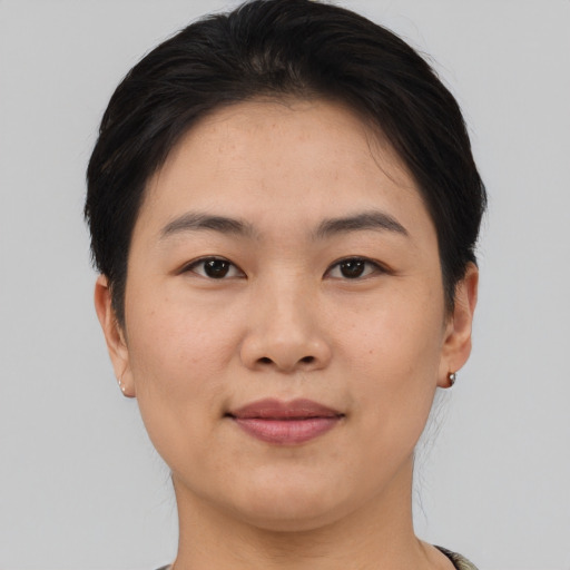 Joyful asian young-adult female with short  brown hair and brown eyes