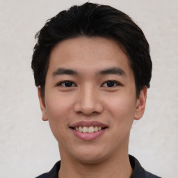 Joyful asian young-adult male with short  black hair and brown eyes