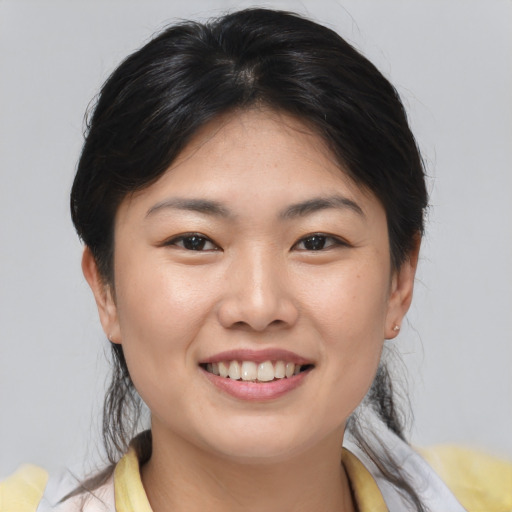 Joyful asian young-adult female with medium  brown hair and brown eyes