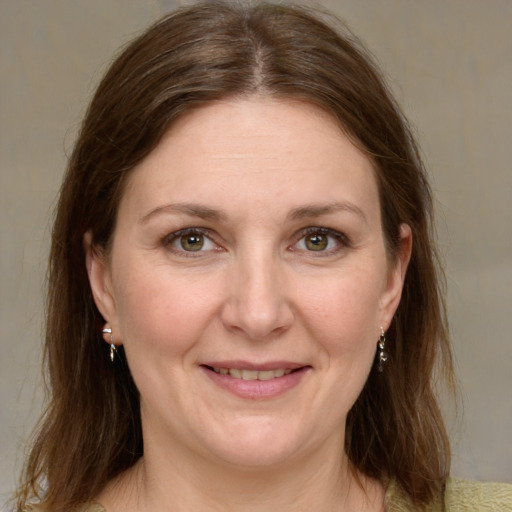 Joyful white adult female with medium  brown hair and grey eyes