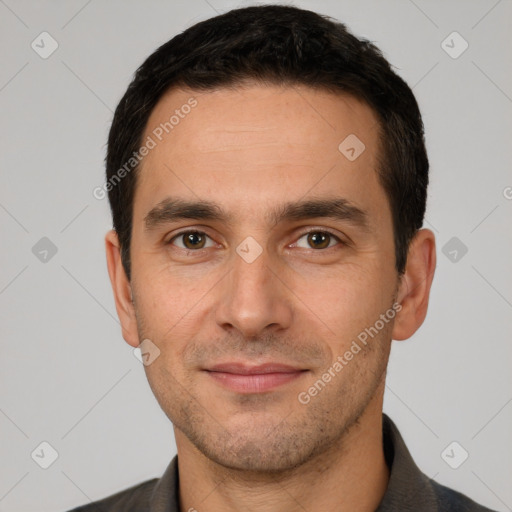 Joyful white young-adult male with short  black hair and brown eyes