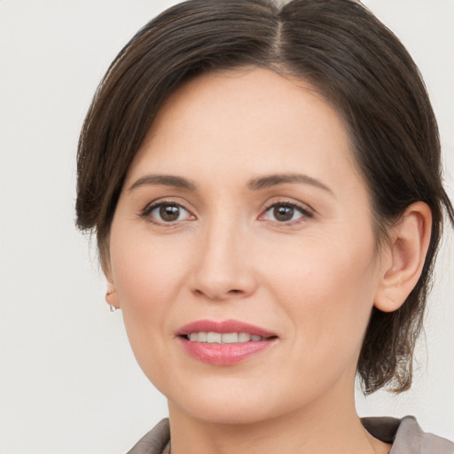 Joyful white young-adult female with medium  brown hair and brown eyes