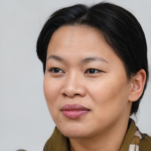 Joyful asian young-adult female with medium  brown hair and brown eyes