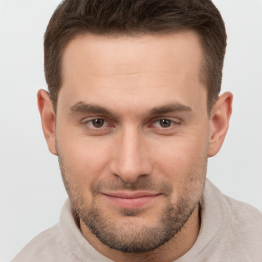 Joyful white young-adult male with short  brown hair and brown eyes