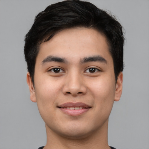 Joyful asian young-adult male with short  black hair and brown eyes