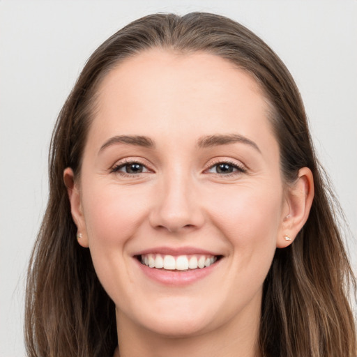 Joyful white young-adult female with long  brown hair and grey eyes