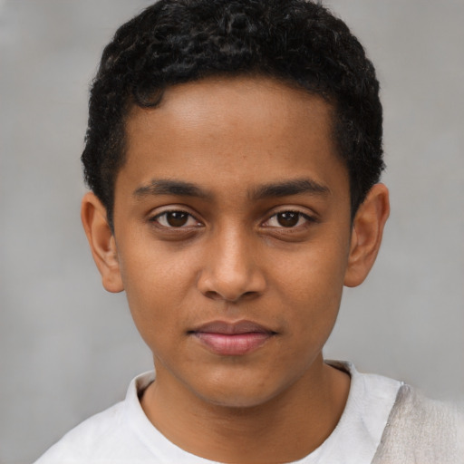 Joyful black child male with short  black hair and brown eyes