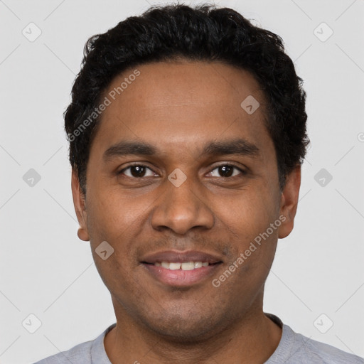 Joyful black young-adult male with short  black hair and brown eyes