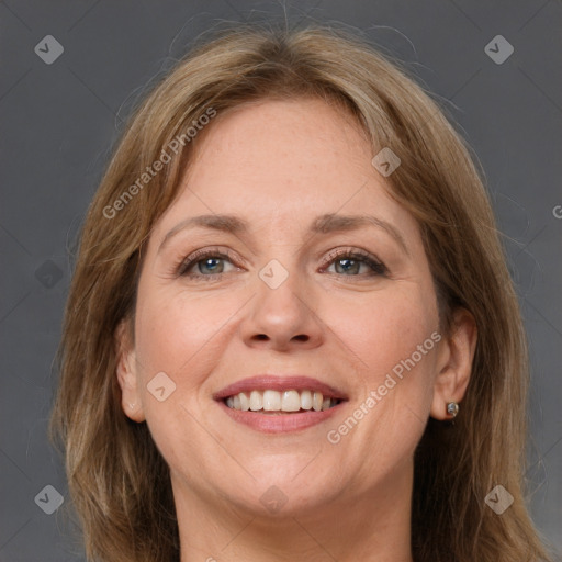 Joyful white adult female with long  brown hair and grey eyes