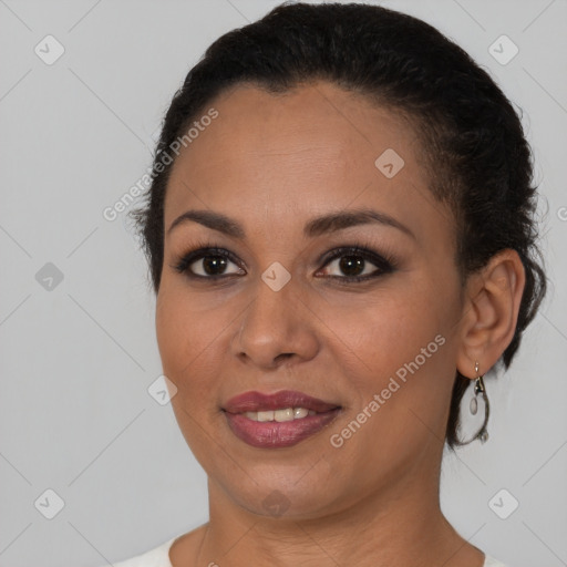 Joyful black young-adult female with short  brown hair and brown eyes