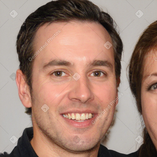 Joyful white adult male with short  brown hair and brown eyes