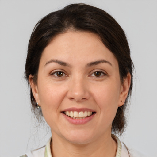 Joyful white young-adult female with medium  brown hair and brown eyes