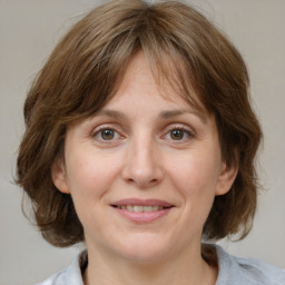 Joyful white adult female with medium  brown hair and grey eyes