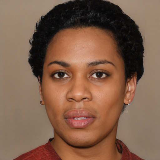 Joyful black young-adult female with short  black hair and brown eyes
