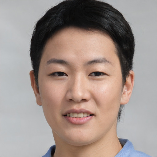 Joyful asian young-adult male with short  black hair and brown eyes
