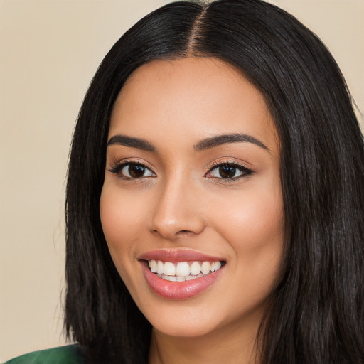 Joyful latino young-adult female with long  black hair and brown eyes