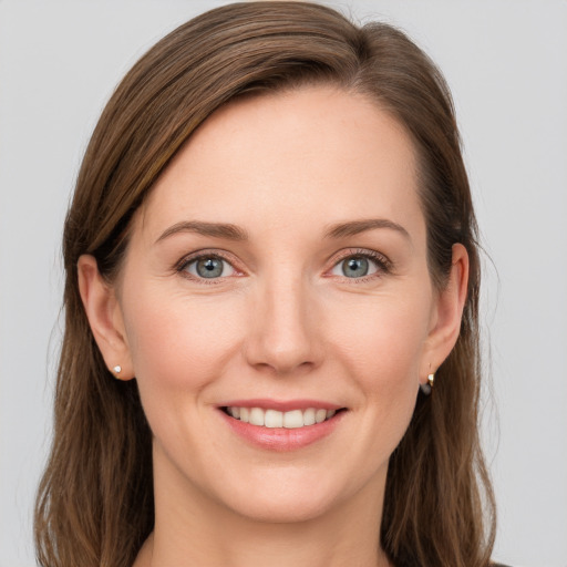 Joyful white young-adult female with long  brown hair and blue eyes