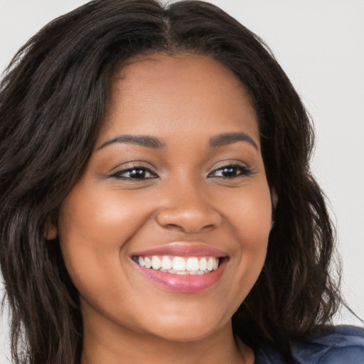 Joyful latino young-adult female with long  brown hair and brown eyes