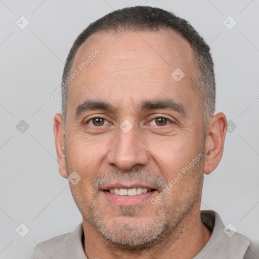 Joyful white adult male with short  brown hair and brown eyes