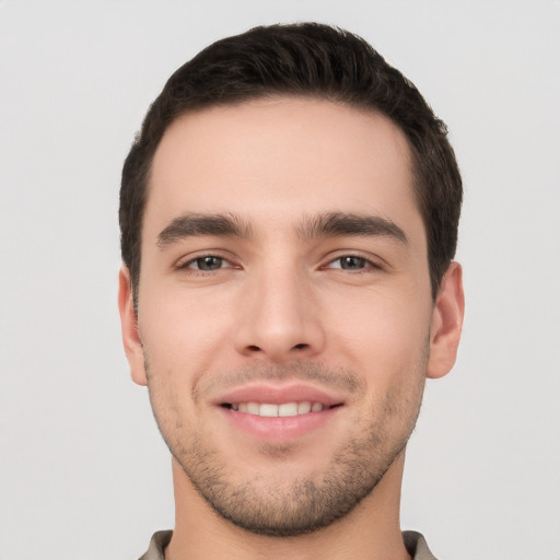 Joyful white young-adult male with short  black hair and brown eyes