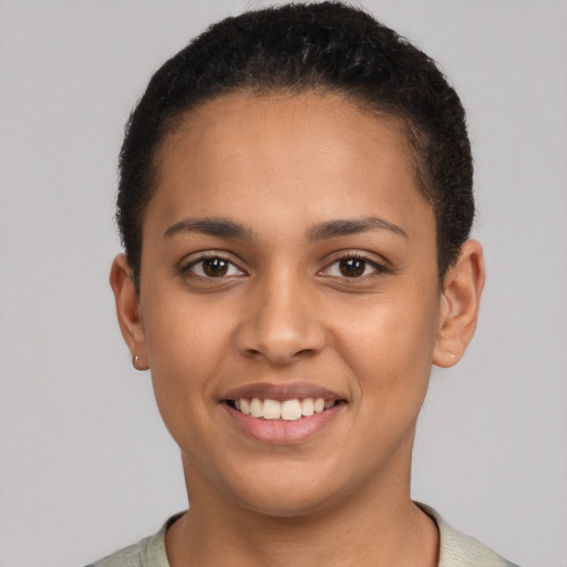 Joyful latino young-adult female with short  brown hair and brown eyes