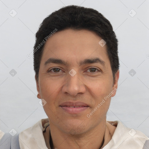 Joyful latino adult male with short  black hair and brown eyes