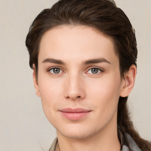 Joyful white young-adult female with short  brown hair and grey eyes