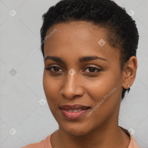 Joyful black young-adult female with short  black hair and brown eyes