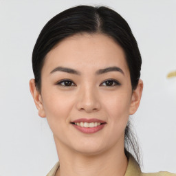 Joyful asian young-adult female with short  black hair and brown eyes