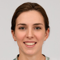 Joyful white young-adult female with medium  brown hair and grey eyes