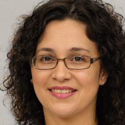 Joyful white adult female with long  brown hair and brown eyes