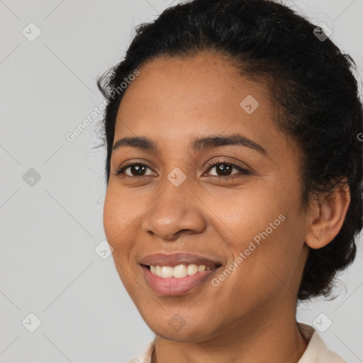 Joyful latino young-adult female with short  black hair and brown eyes