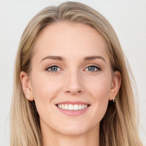 Joyful white young-adult female with long  brown hair and blue eyes