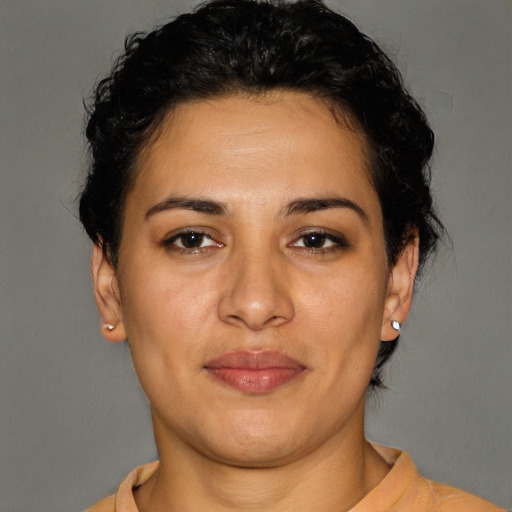 Joyful latino young-adult female with short  brown hair and brown eyes