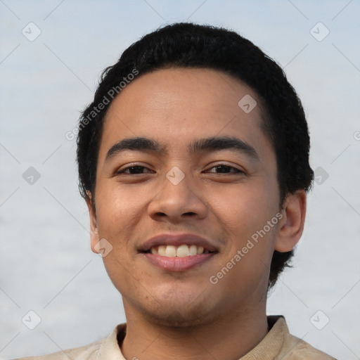 Joyful latino young-adult male with short  black hair and brown eyes