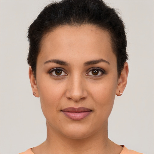 Joyful latino young-adult female with short  brown hair and brown eyes