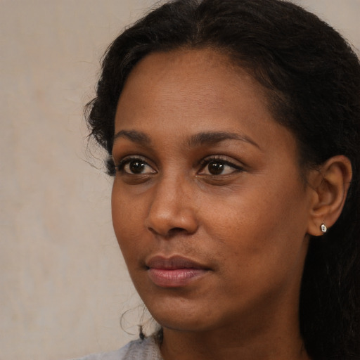 Neutral black young-adult female with long  brown hair and brown eyes