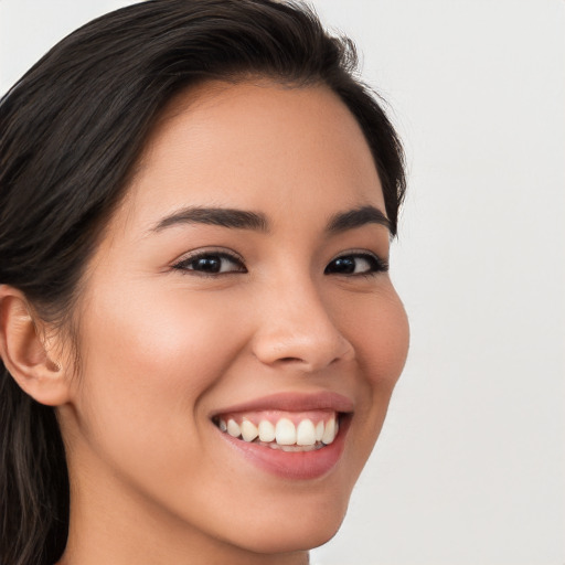 Joyful white young-adult female with long  brown hair and brown eyes