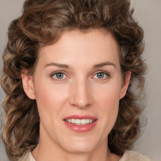 Joyful white young-adult female with medium  brown hair and green eyes