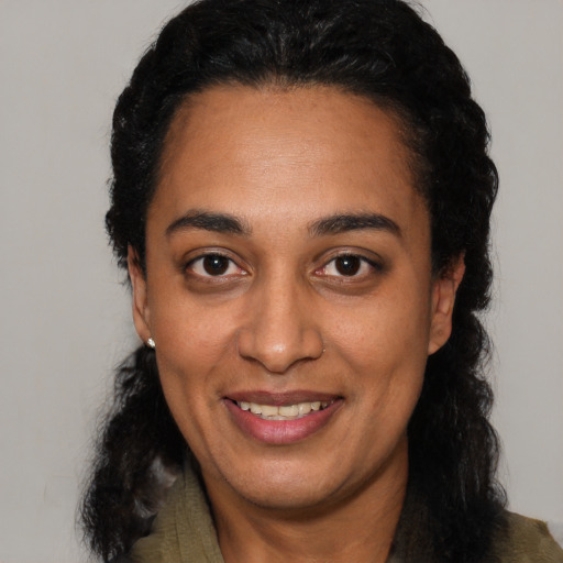 Joyful latino young-adult female with medium  black hair and brown eyes