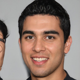 Joyful white young-adult male with short  black hair and brown eyes