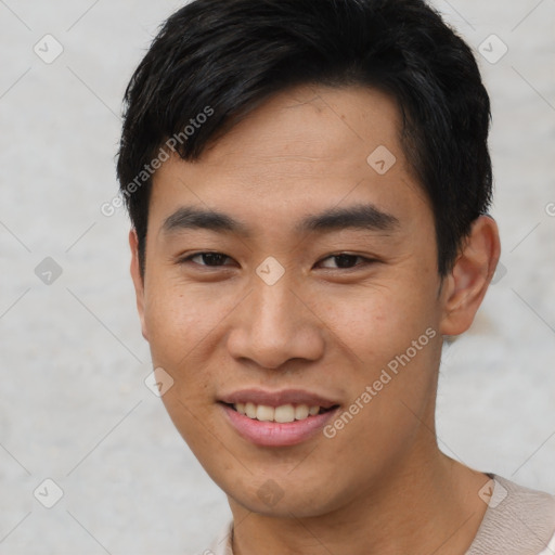 Joyful asian young-adult male with short  black hair and brown eyes