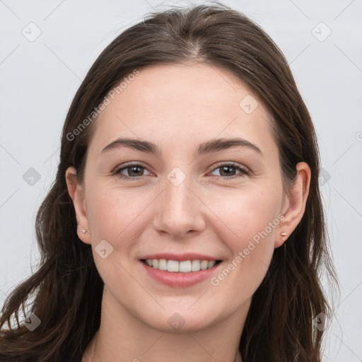 Joyful white young-adult female with long  brown hair and grey eyes