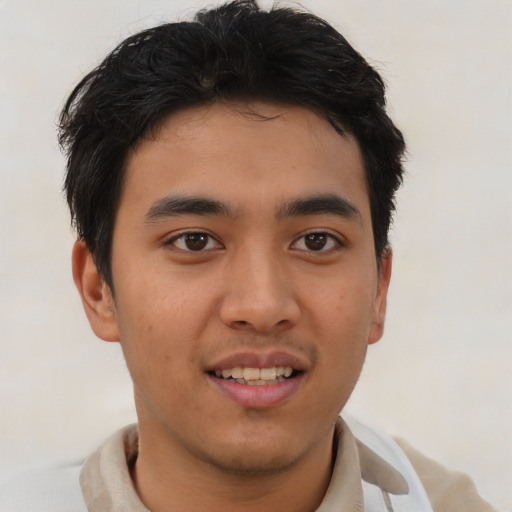 Joyful asian young-adult male with short  brown hair and brown eyes