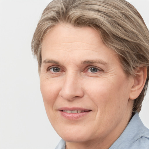 Joyful white adult female with medium  brown hair and grey eyes