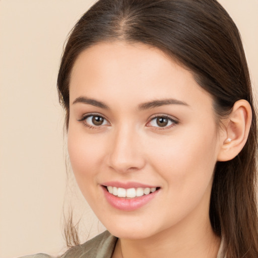 Joyful white young-adult female with long  brown hair and brown eyes