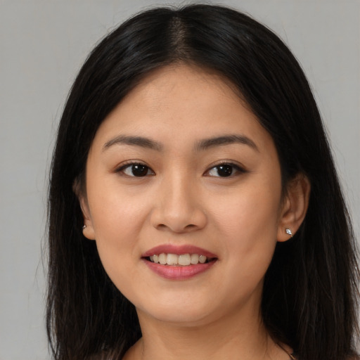 Joyful asian young-adult female with long  brown hair and brown eyes