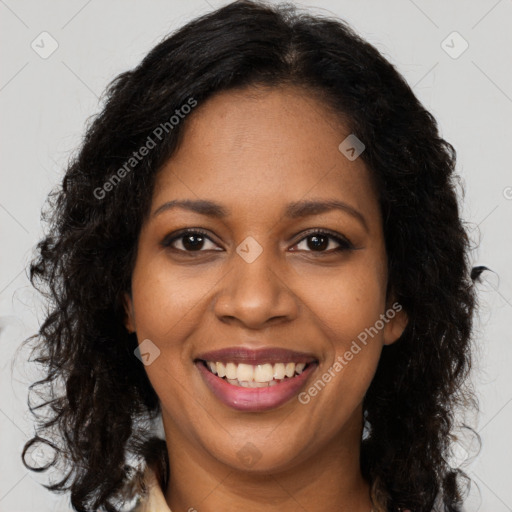 Joyful black young-adult female with long  brown hair and brown eyes