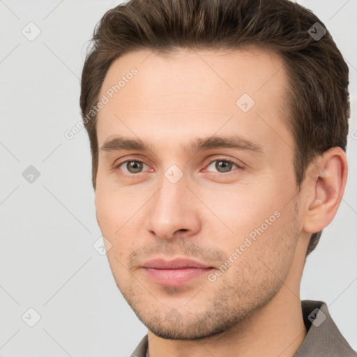 Joyful white young-adult male with short  brown hair and brown eyes