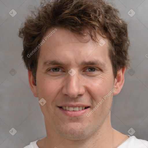 Joyful white adult male with short  brown hair and grey eyes